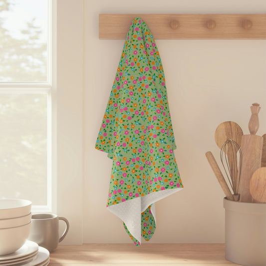 A multi-coloured, loose floral on a bright green background makes this tea towel a great addition to your kitchen! Artwork by Bridget M. Designs.